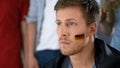 Upset German football fan disappointed with defeat, watching game with friends