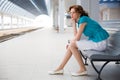 Upset girl on railway station Royalty Free Stock Photo