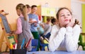 Upset girl in schoolroom during break