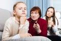 Upset girl scolded by mother and grandma