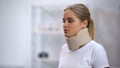 Upset girl wearing neck collar, sprain and therapy concept, rehabilitation