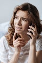 Upset gloomy woman receiving unpleasant news Royalty Free Stock Photo