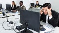 Upset Hispanic businessman worriedly looking at computer monitor in modern open plan office Royalty Free Stock Photo