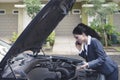 Upset Indian business woman talking on the phone asking for a mechanic help to fix broken down car Royalty Free Stock Photo