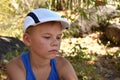 Upset kid boy sitting on the ground. Royalty Free Stock Photo