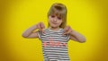 Upset kid child girl showing thumbs down sign gesture, expressing discontent, disapproval, dislike Royalty Free Stock Photo