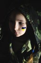 upset kid with painted ukrainian flag