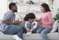 Upset little african american girl sitting between quarreling parents on couch Royalty Free Stock Photo