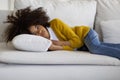 Upset little black girl lying on couch at home Royalty Free Stock Photo