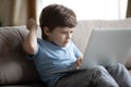 Upset little boy feel distressed using laptop Royalty Free Stock Photo