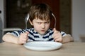 Upset little boy waiting for dinner Royalty Free Stock Photo