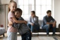 Upset little girl and boy hugging, suffering from parents quarrel Royalty Free Stock Photo
