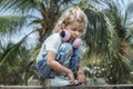 Upset lonely caucasian kid girl with headphones looking away.