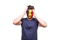 Upset loser fan support of Belgium national team with painted face isolated on white background