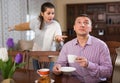 Upset man and frustrated woman arguing at home