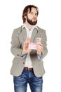 Upset man holding gift box, displeased with what he received, di Royalty Free Stock Photo