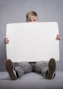 Upset man holding white empty panel.