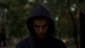 Upset man in hood looking down, feeling guilty and regretting criminal past Royalty Free Stock Photo