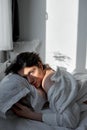 Upset man lying on bed in his bedroom Royalty Free Stock Photo