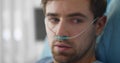 Upset man lying with oxygen nasal catheter on face preparing for surgery Royalty Free Stock Photo