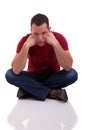 Upset man sitting cross-legged on the floor Royalty Free Stock Photo