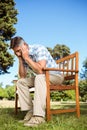 Upset man sitting on park bench