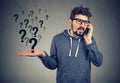 Upset man talking on mobile phone has many questions Royalty Free Stock Photo