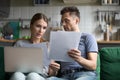 Upset man and woman using laptop, check documents Royalty Free Stock Photo