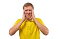 Upset young male in yellow T-shirt clutched at head, forgetful man, isolated on white background Royalty Free Stock Photo