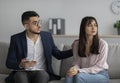 Upset middle eastern lady consulting psychologist, psychotherapist comforting depressed female patient