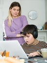 Upset mother arguing with son who plaing video games Royalty Free Stock Photo