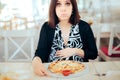 Unhappy Nauseated Pregnant Woman Trying to Eat Pizza