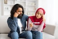 Upset muslim couple with negative pregnancy test sitting on couch at home Royalty Free Stock Photo