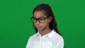 Upset nerd African American teen girl looking away shaking head on green screen. Close-up portrait of sad frustrated