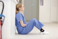 Upset nurse sitting on floor Royalty Free Stock Photo