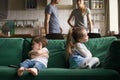 Upset offended brother and sister sitting on couch Royalty Free Stock Photo