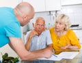 Upset old husband and wife signing agreement papers with social worker