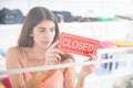 Upset Owner Holding Closed Sign In Clothing Store Royalty Free Stock Photo