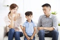 Upset parent and little boy sitting on sofa Royalty Free Stock Photo