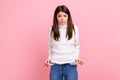 Upset poor girl showing empty pockets and looking frustrated about loans and debts, has no money. Royalty Free Stock Photo