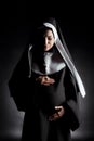 Upset pregnant nun touching belly