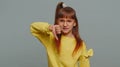 Upset preteen child girl showing thumbs down, dislike bad work, disapproval, dissatisfied feedback Royalty Free Stock Photo