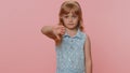 Upset preteen child girl showing thumbs down, dislike bad work, disapproval, dissatisfied feedback Royalty Free Stock Photo