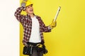 smiling professional builder in work clothes in helmet with level . Royalty Free Stock Photo