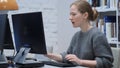 Upset Redhead Woman Working on Computer