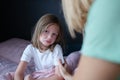 Upset sad little girl communicates with mom at home