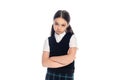 Upset schoolgirl crossing arms and looking