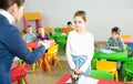 Upset schoolgirl listening reprimanding of teacher