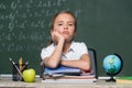 upset schoolgirl looking at camera near