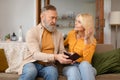 Upset Senior Husband Showing Empty Wallet To Wife At Home Royalty Free Stock Photo